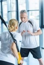 Sportswoman and senior trainer training with resistance band Royalty Free Stock Photo