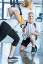 Sportswoman and senior trainer training with resistance band Royalty Free Stock Photo