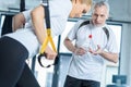 Sportswoman and senior trainer training with resistance band Royalty Free Stock Photo