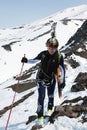 Sportswoman ski mountaineer climbing on mountain