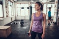 Sportswoman Stands In Gym With Bottle Of Water