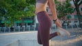 Sportswoman stretching legs warming at stadium closeup. Lady making yoga asana