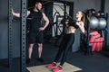 Sportswoman training with trx resistance band while trainer looking at her Royalty Free Stock Photo