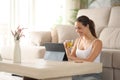 Sportswoman watching online exercise tutorial on tablet drinkig tea Royalty Free Stock Photo