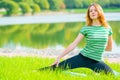 Sportswomen do exercises on the lush grass