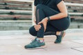 Sportwoman holds on to her injured leg on treadmill Royalty Free Stock Photo