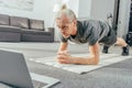 sporty adult man doing plank exercise and looking