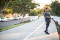 A sporty African American girl standing on a bike path in the ci Royalty Free Stock Photo