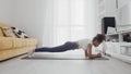 Slim sporty african american woman practicing yoga on a mat. Woman in activewear perform plank position exercise on mat Royalty Free Stock Photo