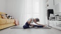 Slim sporty african american woman practicing yoga on a mat. Woman sits on fitness mat and stretches Royalty Free Stock Photo