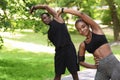 Sporty African Couple Doing Fitness Workout Together In Summer Park, Stretching Muscles Royalty Free Stock Photo