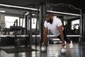 Sporty african man doing push-up in a gym. Royalty Free Stock Photo