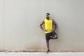 Sporty afro man standing near old wall, doing morning gymnastics Royalty Free Stock Photo