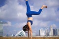 Sporty Asian Chinese Female Yoga practioner exercising kicking up to a handstand