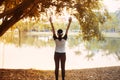 Sporty asian woman enjoying and freedom with open hands,Female rise hands up enjoy nature outdoor Royalty Free Stock Photo