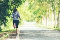 Sporty asian woman runner running and jogging through the road.  Outdoor Workout in a Park Royalty Free Stock Photo