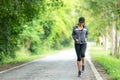 Sporty asian woman runner running and jogging through the road. Royalty Free Stock Photo