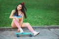 Sporty asian woman with skateboard Royalty Free Stock Photo