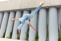 Sporty athlete flying and flipping above ground on the street.