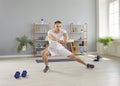 Sporty athletic man exercising at home on the floor. Fitness and home training concept. Royalty Free Stock Photo
