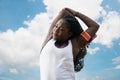 Sporty attractive african woman doing exercise over blue sky background Royalty Free Stock Photo