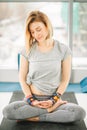 Sporty attractive woman sitting in Lotus pose