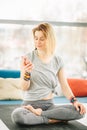 Sporty attractive woman sitting in Lotus pose