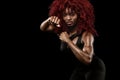 Sporty beautiful afro-american model, woman in sportwear makes fitness exercising at black background to stay fit