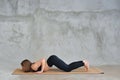 Sporty beautiful blond young woman in sportswear working out indoors, doing Eight-Limbed Posture, Ashtanga Namaskarasana on eco