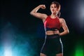 Sporty beautiful woman doing fitness gym exercising at black background to stay fit.