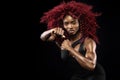 Sporty beautiful afro-american model, woman in sportwear makes fitness exercising at black background to stay fit Royalty Free Stock Photo