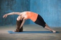 Sporty beautiful young woman doing Vasisthasana pose