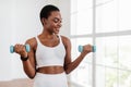 Sporty Black Female Exercising With Two Dumbbells And Posing Royalty Free Stock Photo