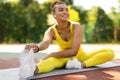 Sporty Black Female In Yellow Sportswear Stretching Leg Outdoors Royalty Free Stock Photo
