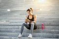 Sporty black girl in using phone while resting Royalty Free Stock Photo