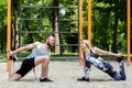 Sporty blonde girl and bearded man is warming up before training Royalty Free Stock Photo