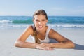 Sporty blonde lying on the beach smiling at camera Royalty Free Stock Photo