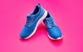 sporty blue sneakers pair on pink background, sneakers