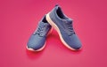 sporty blue sneakers pair on pink background, sneakers