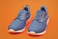 sporty blue sneakers. shoes on orange background. shoe store. shopping concept. Royalty Free Stock Photo