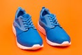 sporty blue sneakers. shoes on orange background. shoe store. shopping concept. Royalty Free Stock Photo