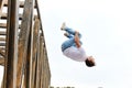 Sporty brave man performing risky stunt while jumping high in the air