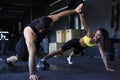 Sporty couple doing push ups and giving high five to each other in gym Royalty Free Stock Photo