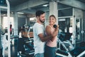 Sporty couple exercising dumbbell weights lifting in fitness gym., Portrait of attractive young couple are practicing workout in Royalty Free Stock Photo