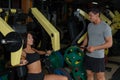 Sporty couple trains on exercise machine in gym Royalty Free Stock Photo