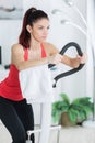 sporty determined training on step machine in bright living room