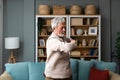 Sporty elderly guy practicing yoga indoors. Senior man doing stretching exercise at home. Active lifestyle and healthcare in any Royalty Free Stock Photo