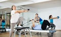 Elderly woman doing stretching exercises on pilates chair Royalty Free Stock Photo