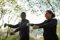 Sporty family. Happy young african fitness couple in sportswear exercising with dumbbells and smiling while working out Royalty Free Stock Photo