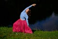 Sporty fit caucasian woman doing asana Virabhadrasana 2 Warrior pose posture in nature. Royalty Free Stock Photo